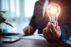 businessman hand holding light bulb